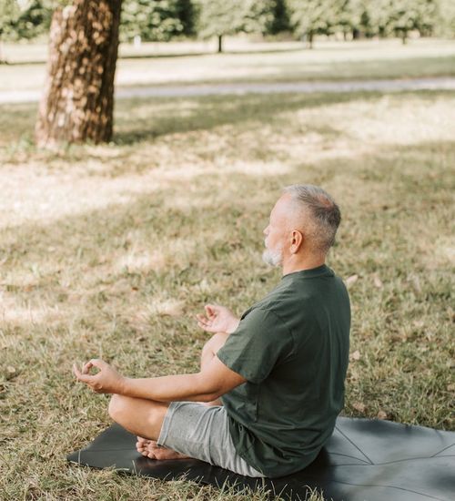 Man meditating in a calm environment, representing mental focus.